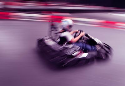 Blurred motion of man go-carting