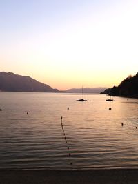 Scenic view of sea against clear sky during sunset