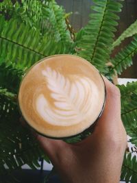 Close-up of hand holding coffee cup