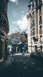Street amidst buildings in city against sky