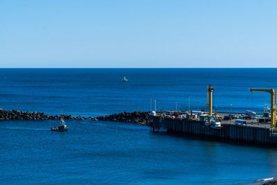 Scenic view of sea against clear blue sky