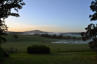 Scenic view of field against sky during sunset