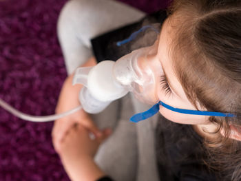 High angle view of woman holding camera