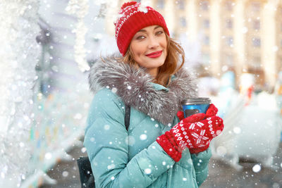 Portrait of smiling woman in snow