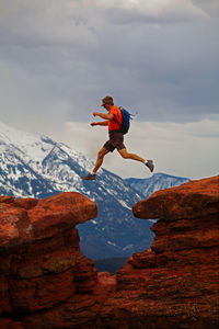 Man jumping between rocks in carbondale / colorado