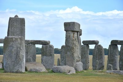 Stone structure against cloudy sky