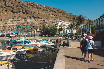 Rear view of man standing on boats