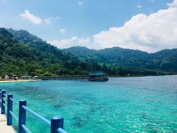 Scenic view of swimming pool by sea against sky