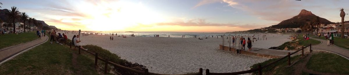 People at beach during sunset