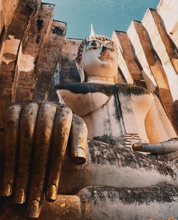 Low angle view of statue against temple