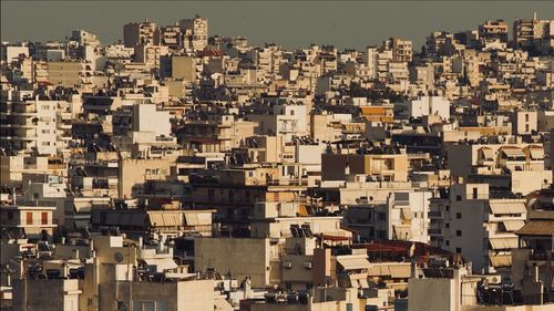 High angle view of buildings in city against sky