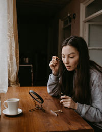 Young woman using mobile phone at home