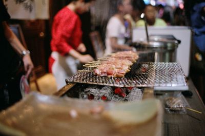 Yakitori grilling on stall at market