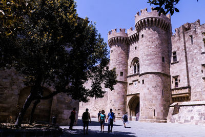 People walking in front of historical building