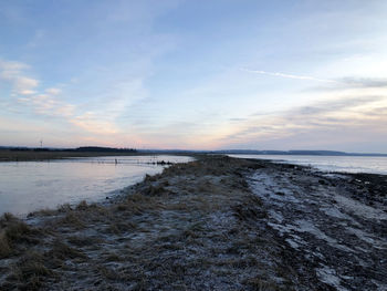 Scenic view of beach against sky during sunset