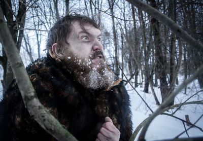 Angry man in forest during winter