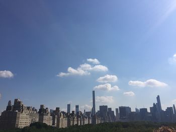 View of cityscape against blue sky