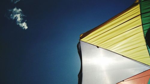 Low angle view of illuminated building against blue sky