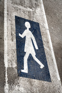 High angle view of pedestrian crossing sign on road