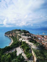 High angle view of buildings by sea against sky