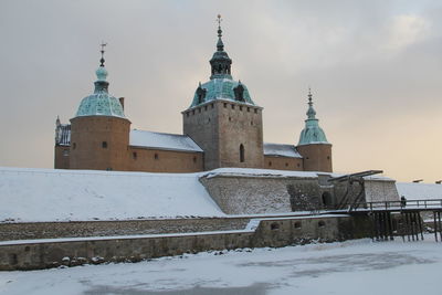 View of snow covered building against sky