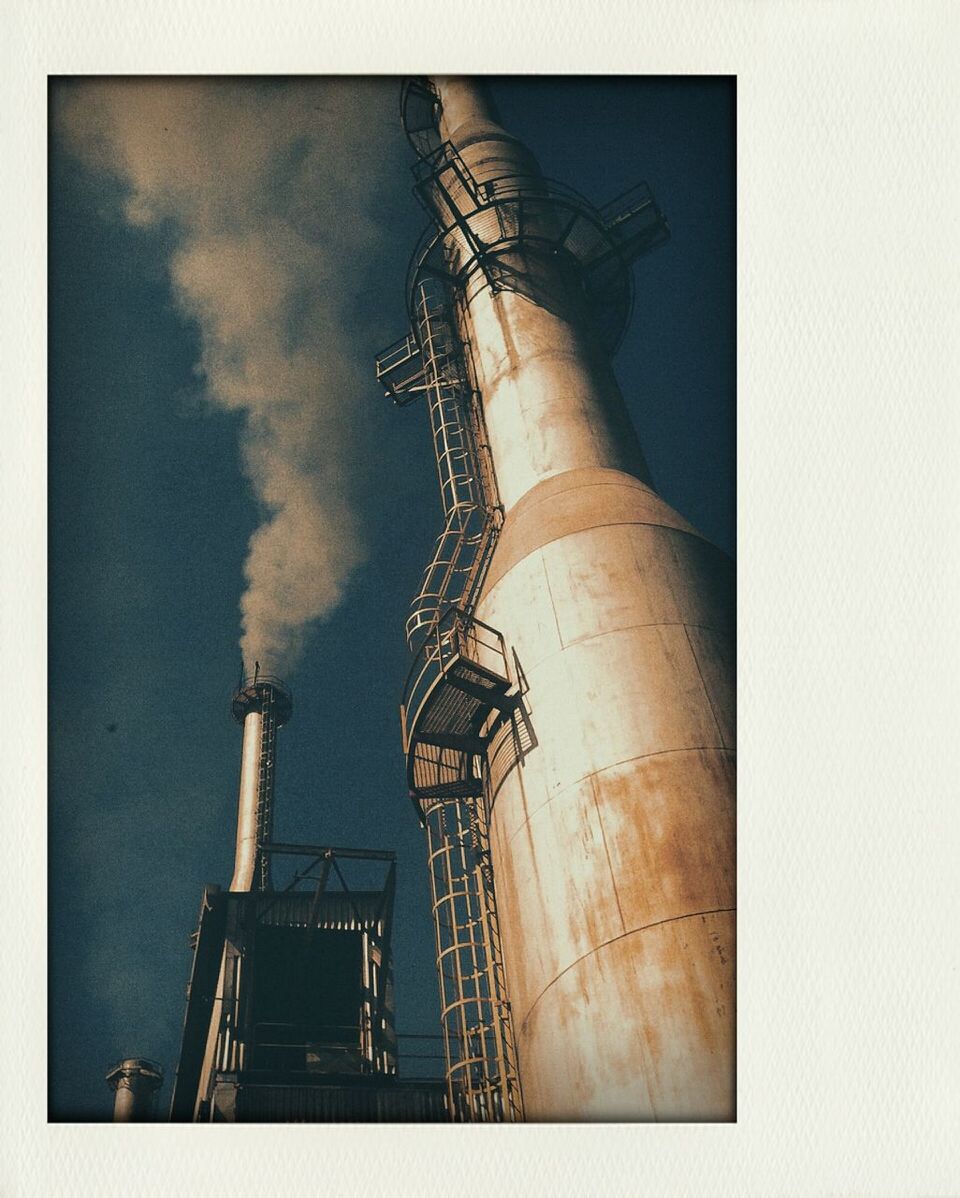 transfer print, low angle view, architecture, building exterior, built structure, auto post production filter, sky, tall - high, tower, day, outdoors, city, construction site, building, no people, industry, cloud - sky, development, tall, modern