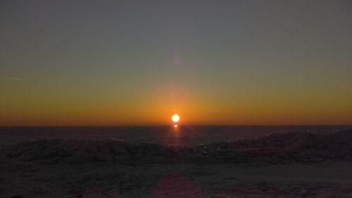 Scenic view of sea against clear sky during sunset