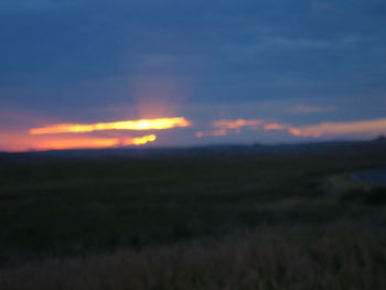 Scenic view of landscape against sky at sunset