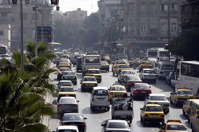 High angle view of cars on road amidst buildings in city