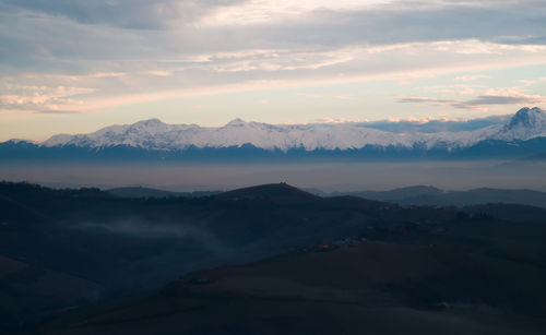 Scenic view of mountains against sky during sunset