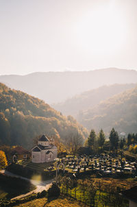 Scenic view of mountains and houses against sky