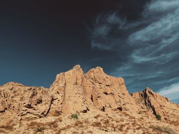 Low angle view of rock formations against sky