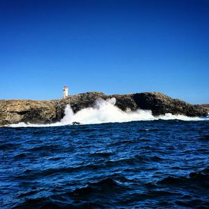 Scenic view of sea against clear blue sky