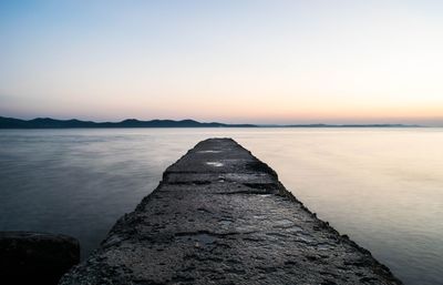 Scenic view of calm sea at sunset