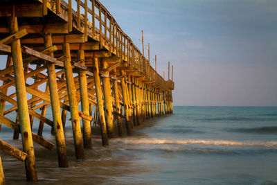 Pier over sea against sky