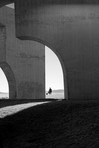 People walking on arch bridge