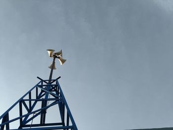 Speaker tower against blue sky background