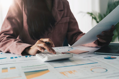 Midsection of businessman working at office