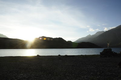 Scenic view of lake against cloudy sky