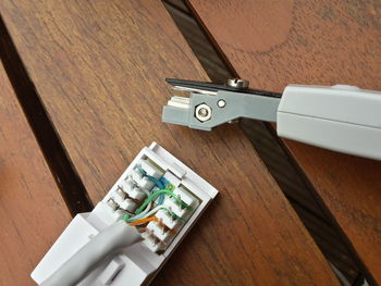 High angle view of electrical outlet with tool on table