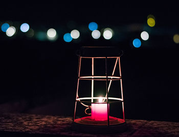 Close-up of lit tea light candle at night