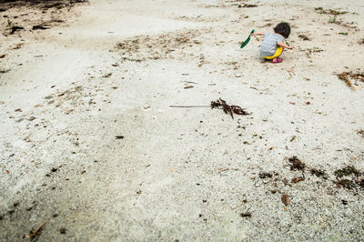 High angle view of child playing on sand