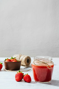 Close-up of fruits on table against wall