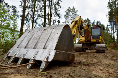 Excavator clearing forest for new development and road work. backhoe for forestry work. 