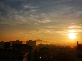 Silhouette buildings against sky during sunset