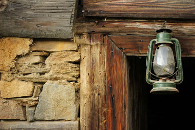 Low angle view of lantern hanging against wall