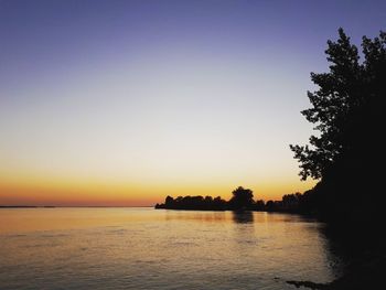 Scenic view of sea against clear sky during sunset