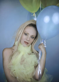 Portrait of a beautiful young woman with balloons