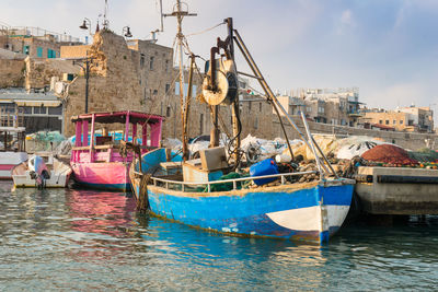 Fishing boats in sea against sky