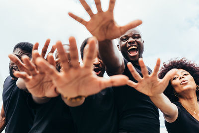 Midsection of woman with arms raised